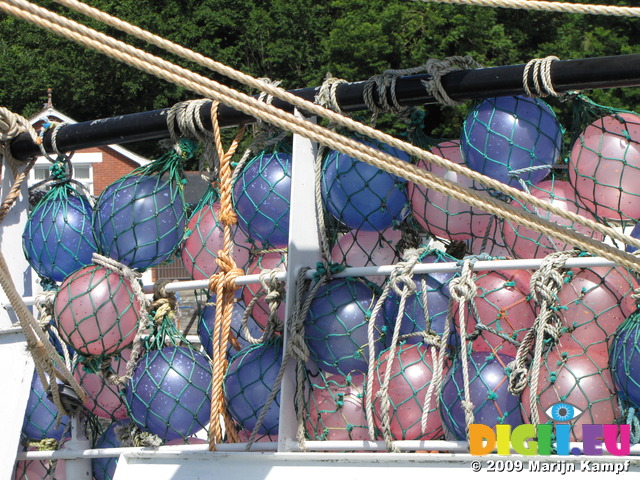 SX07482 Purple and pink bouys on boat in Padstow harbour